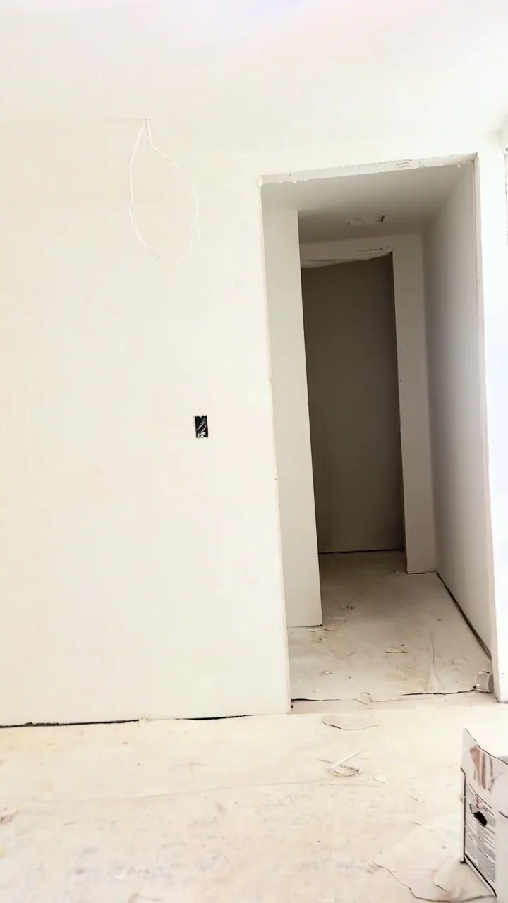 Walls, ceiling edges and door openings during drywall finishing, before final decorating.