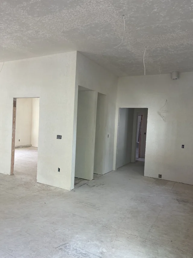 Smooth drywall surfaces around connecting rooms and doorways.